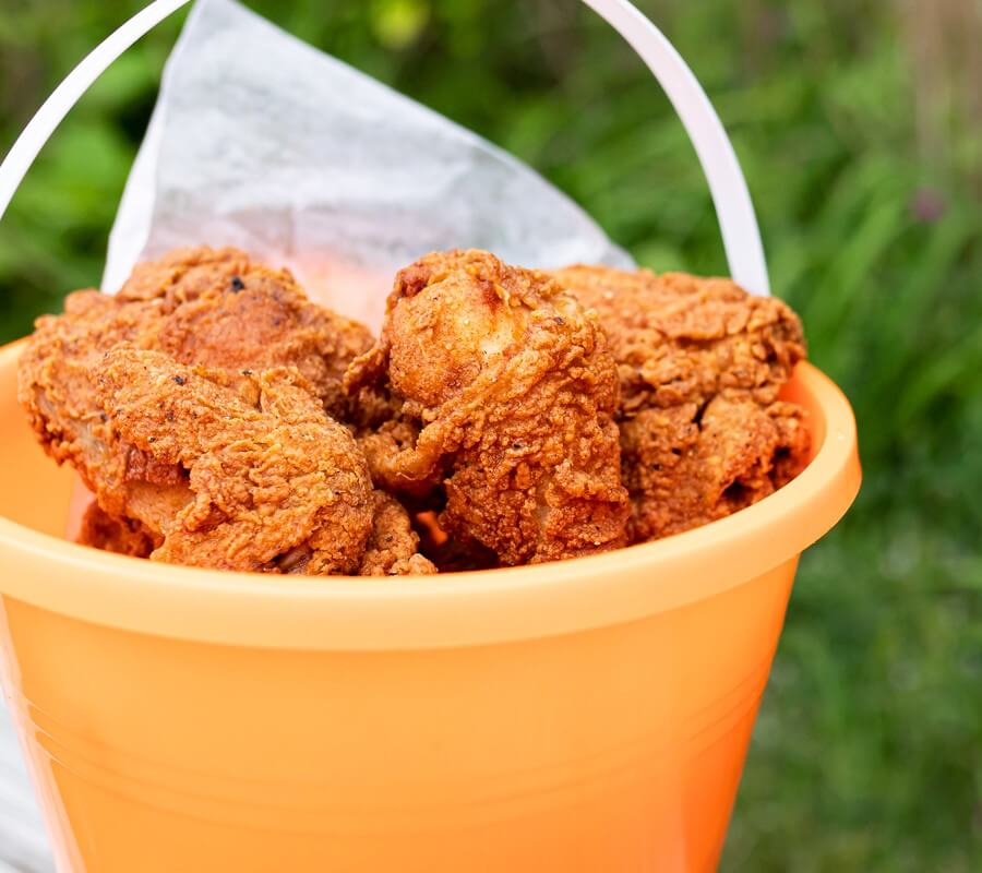 fried chicken in a beach pail