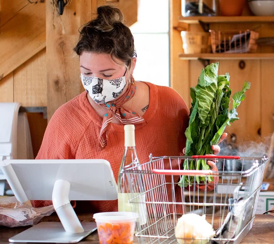 woman wearing a face mask behind counter