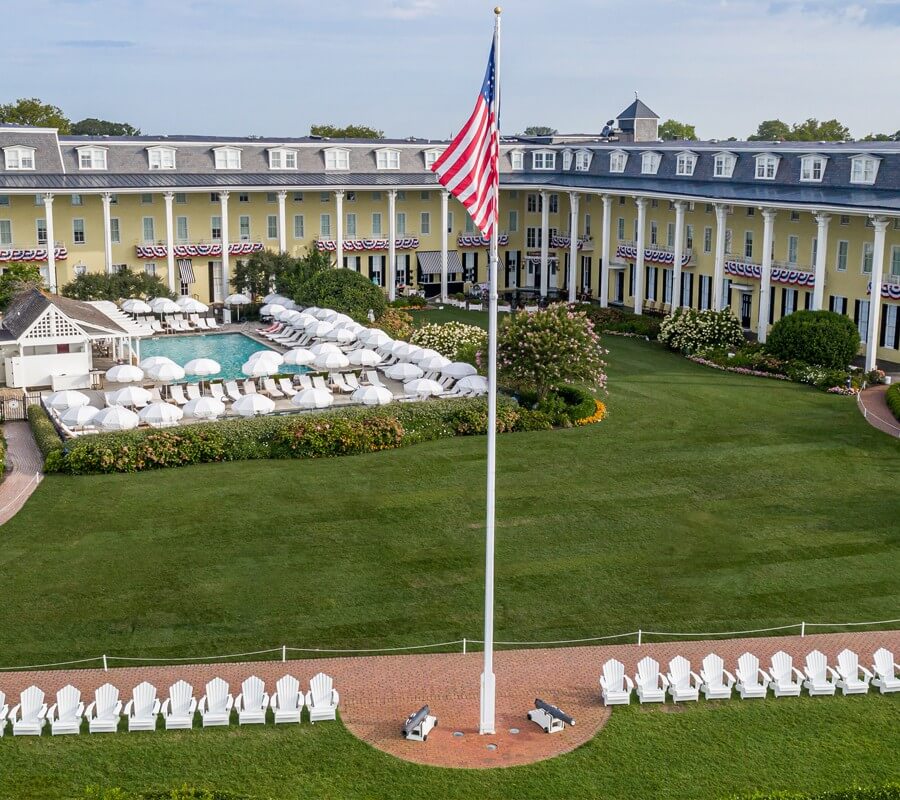 Green Lawn and flagpole with American flag in front of building