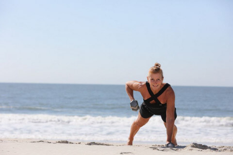beach boot camp instructor in front of the ocean
