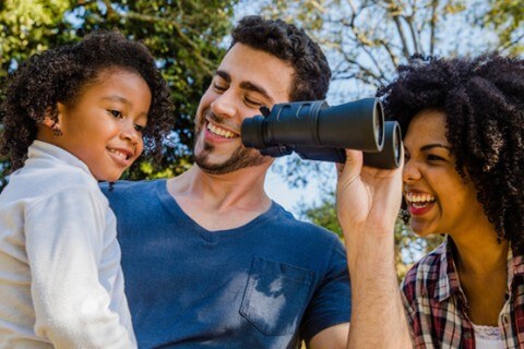 family holding binoculars