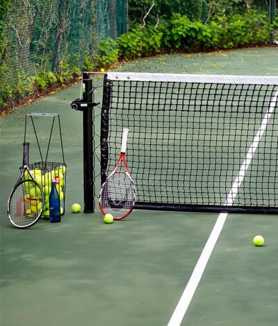 tennis court with racquet and tennis balls