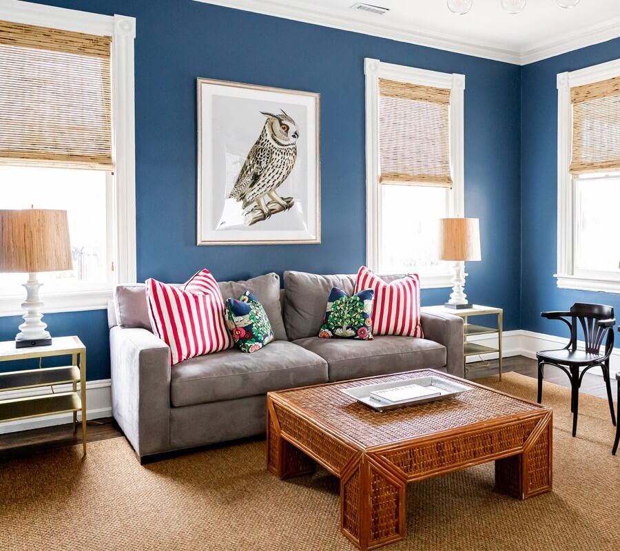 White Cottage living room with blue-painted walls, couch, coffee table and chairs