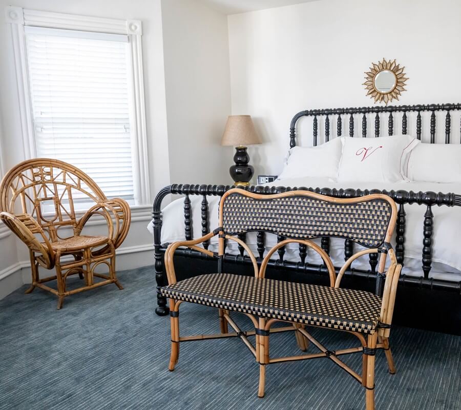 wicker chairs by a bed