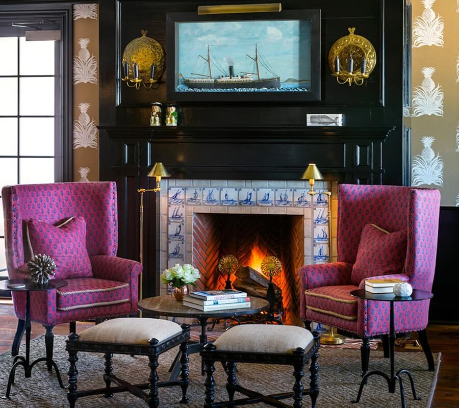 Baron's Cove lobby lounge with pink chairs and fireplace