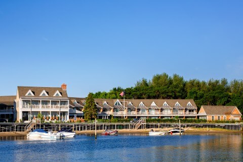 Barons Cove Hotel on the water with boats in the forground
